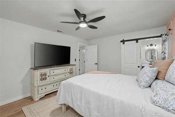 a bedroom with a bed couch and window