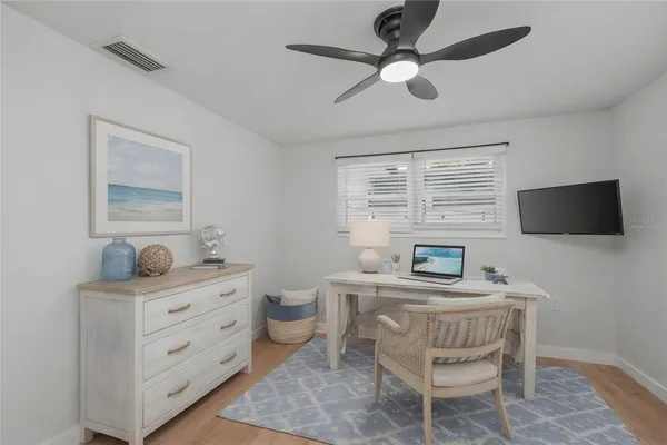 a bathroom with a toilet a sink a mirror a vanity and shower