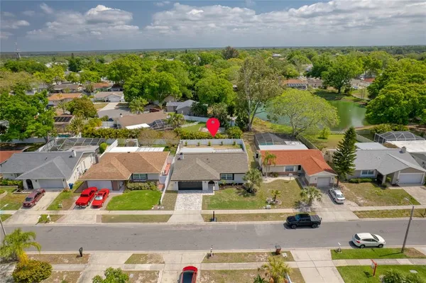 an aerial view of multiple houses with a street