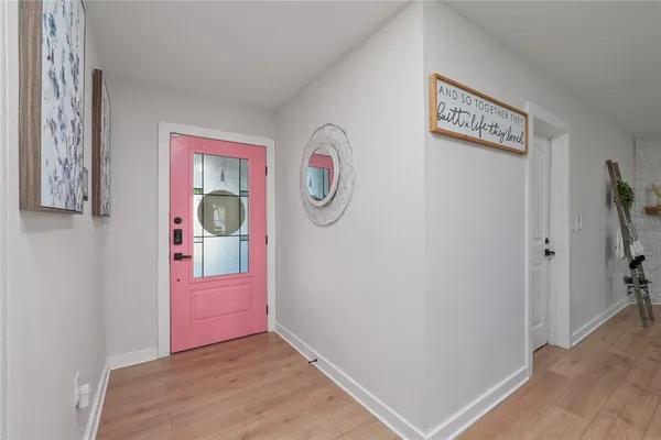 a view of an entryway with wooden floor