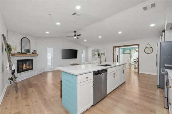 a large kitchen with stainless steel appliances granite countertop a stove and a sink