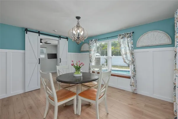a view of a dining room with furniture window and wooden floor