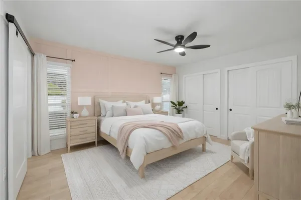 a bedroom with bed and a chandelier