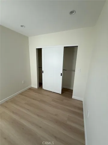 a view of an empty room with closet