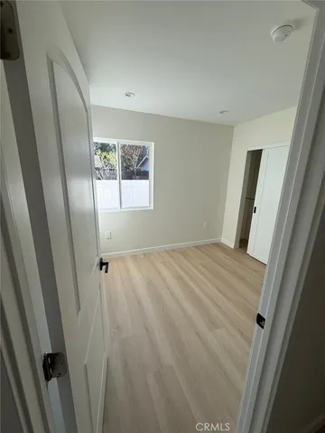 wooden floor in an empty room with a mirror