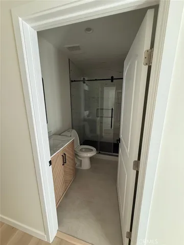 a bathroom with a toilet and a shower