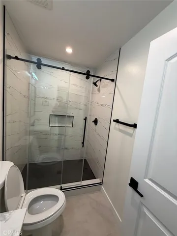 a bathroom with a toilet and a shower