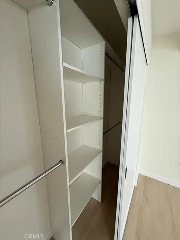a kitchen with granite countertop white cabinets and black appliances