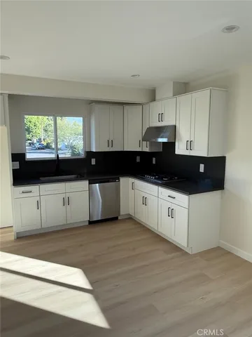 a view of a bedroom with wooden floor and closet
