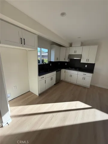a kitchen with stainless steel appliances a white counter top and a refrigerator