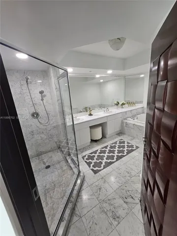 a bedroom with a bed and flat tv screen on the dresser