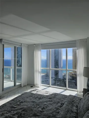 a bedroom with a bed and a mirror on dresser