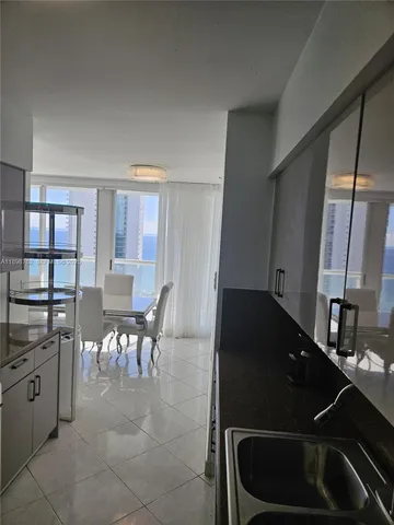 a bathroom with a sink and glass door