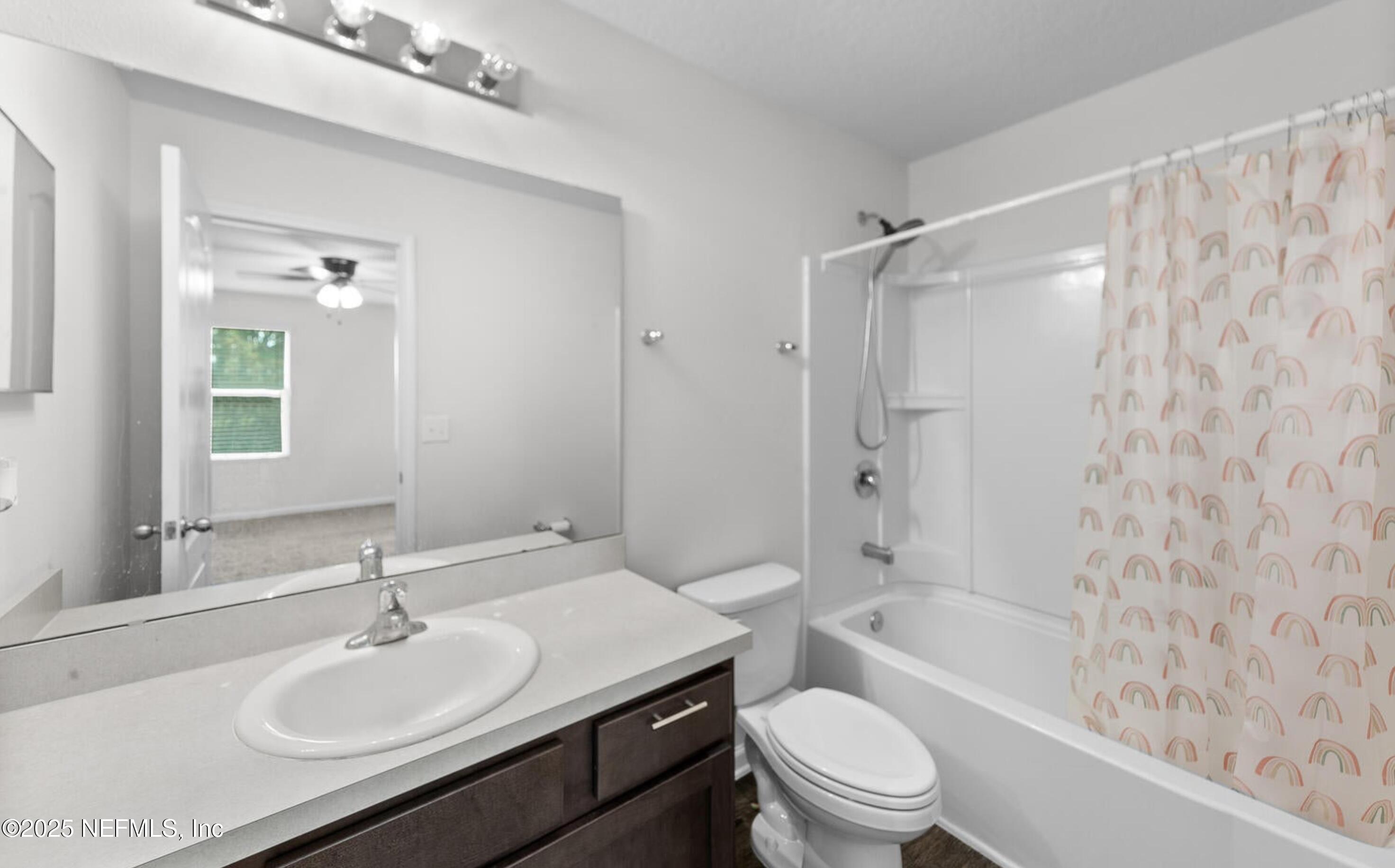 8039 Echo Springs Road Jacksonville, FL 32256 - Photo 15 of 22 a bathroom with a sink a toilet and shower