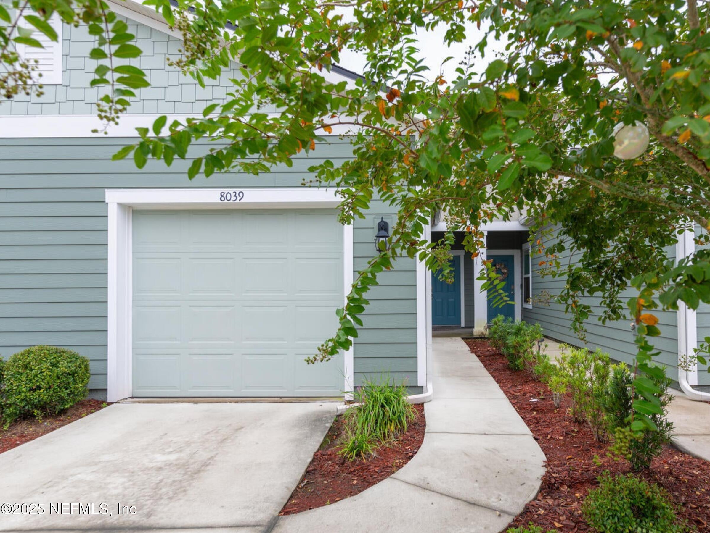 8039 Echo Springs Road Jacksonville, FL 32256 - Photo 2 of 22 a front view of a house with a yard