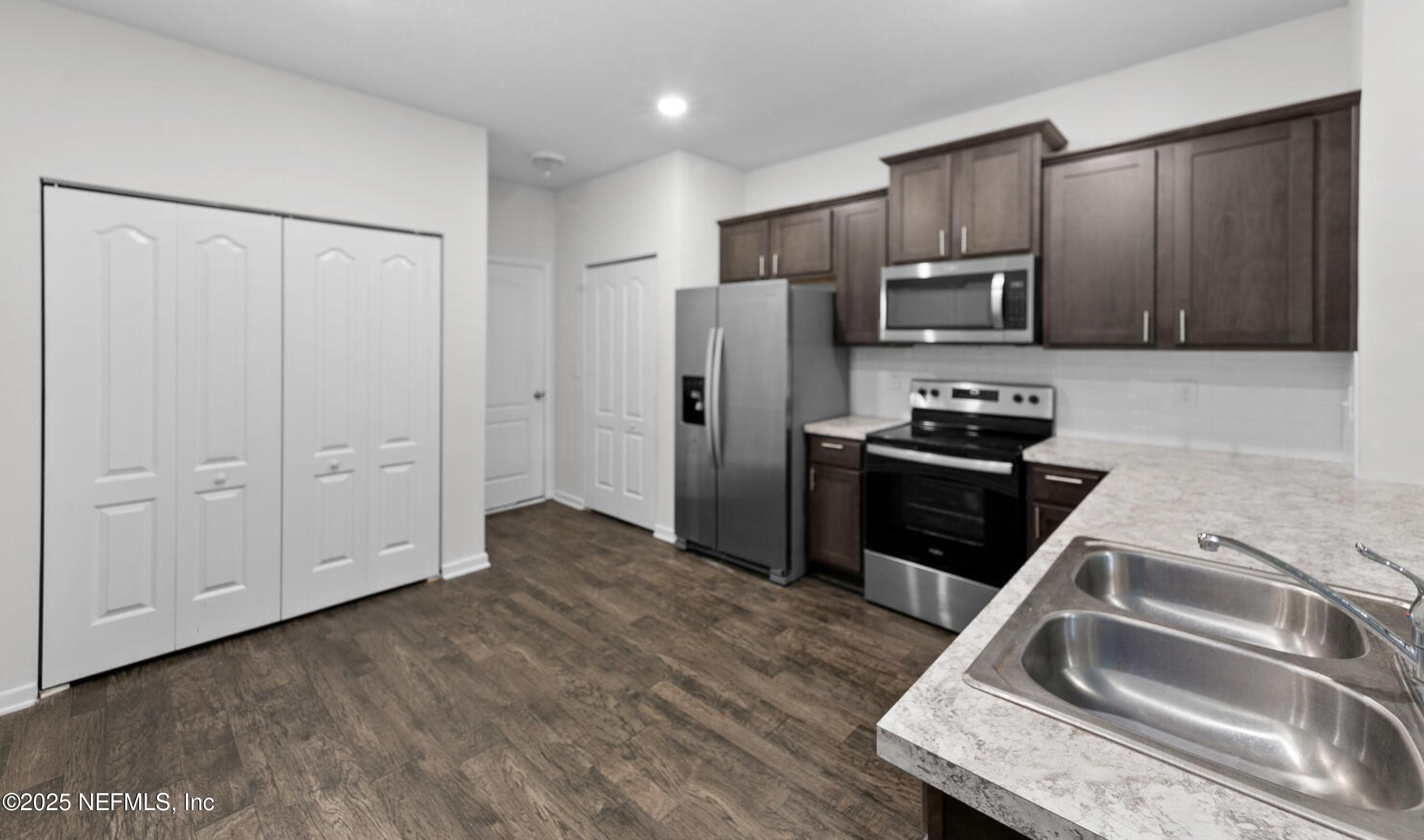 8039 Echo Springs Road Jacksonville, FL 32256 - Photo 5 of 22 a kitchen with a refrigerator sink and microwave