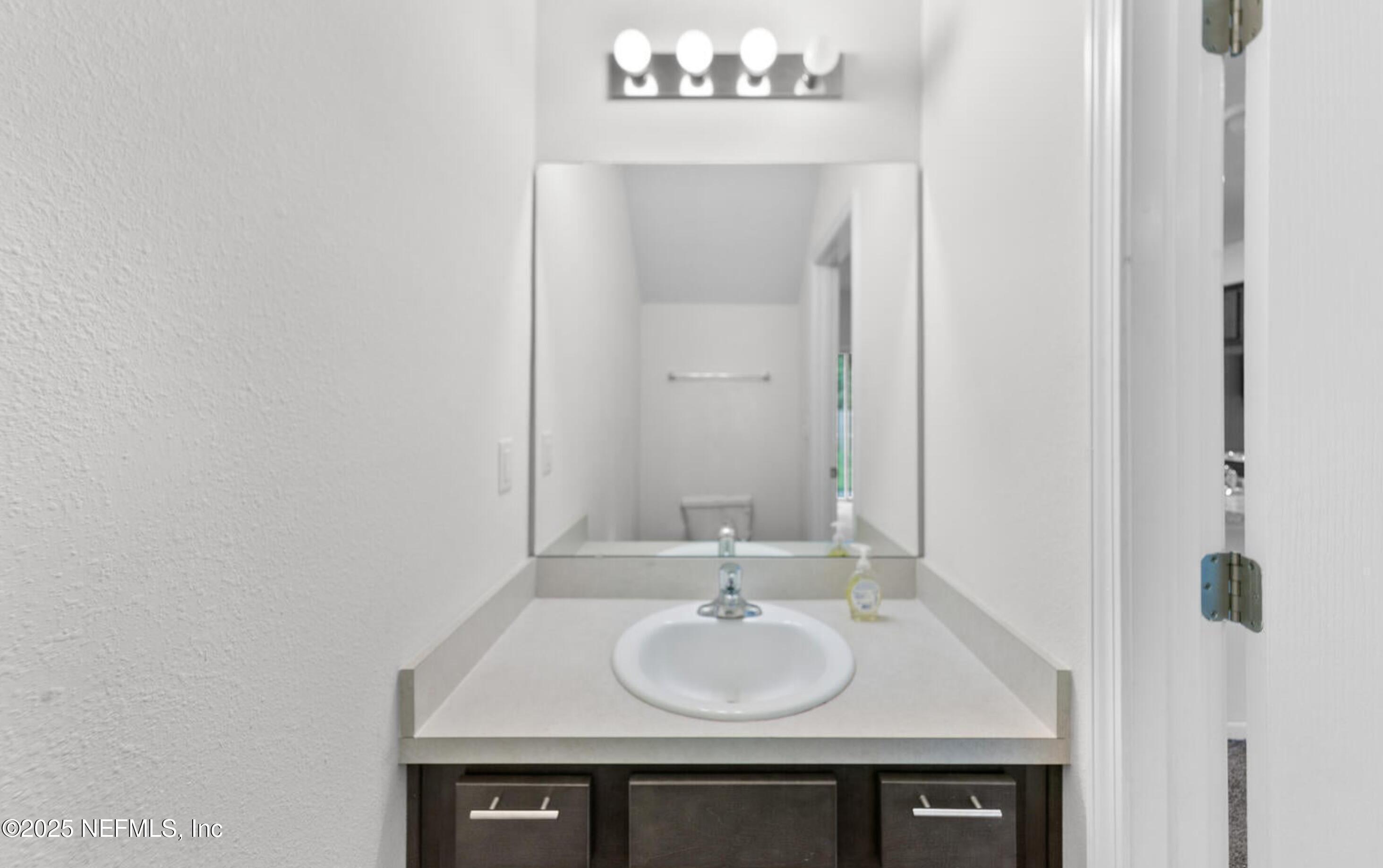 8039 Echo Springs Road Jacksonville, FL 32256 - Photo 9 of 22 a sink and a mirror