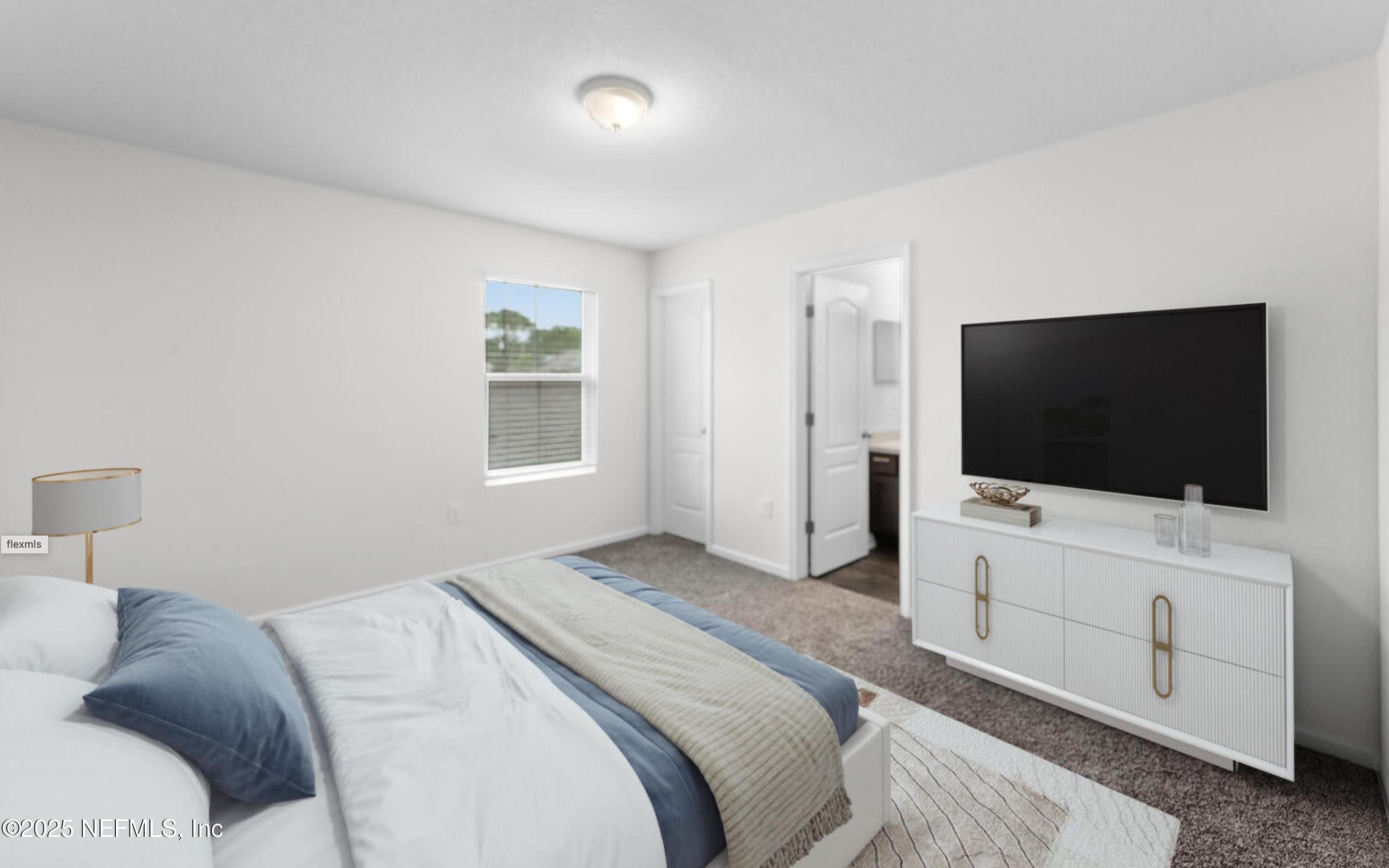 8039 Echo Springs Road Jacksonville, FL 32256 - Photo 10 of 22 a bedroom with a bed and a flat screen tv