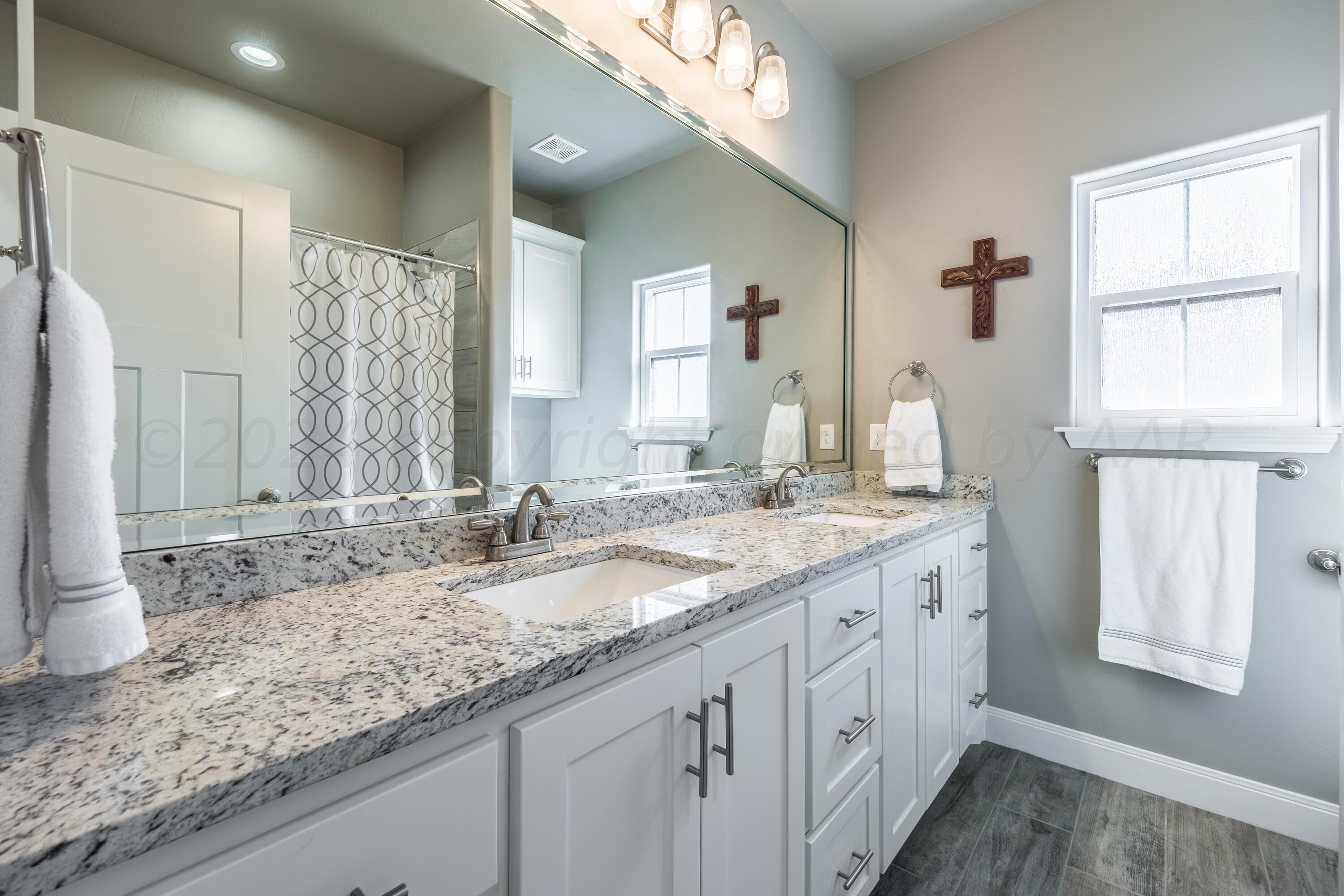 5 Gimball Drive Canyon, TX 79015 - Photo 22 of 36 a bathroom with a granite countertop double vanity sink and a window