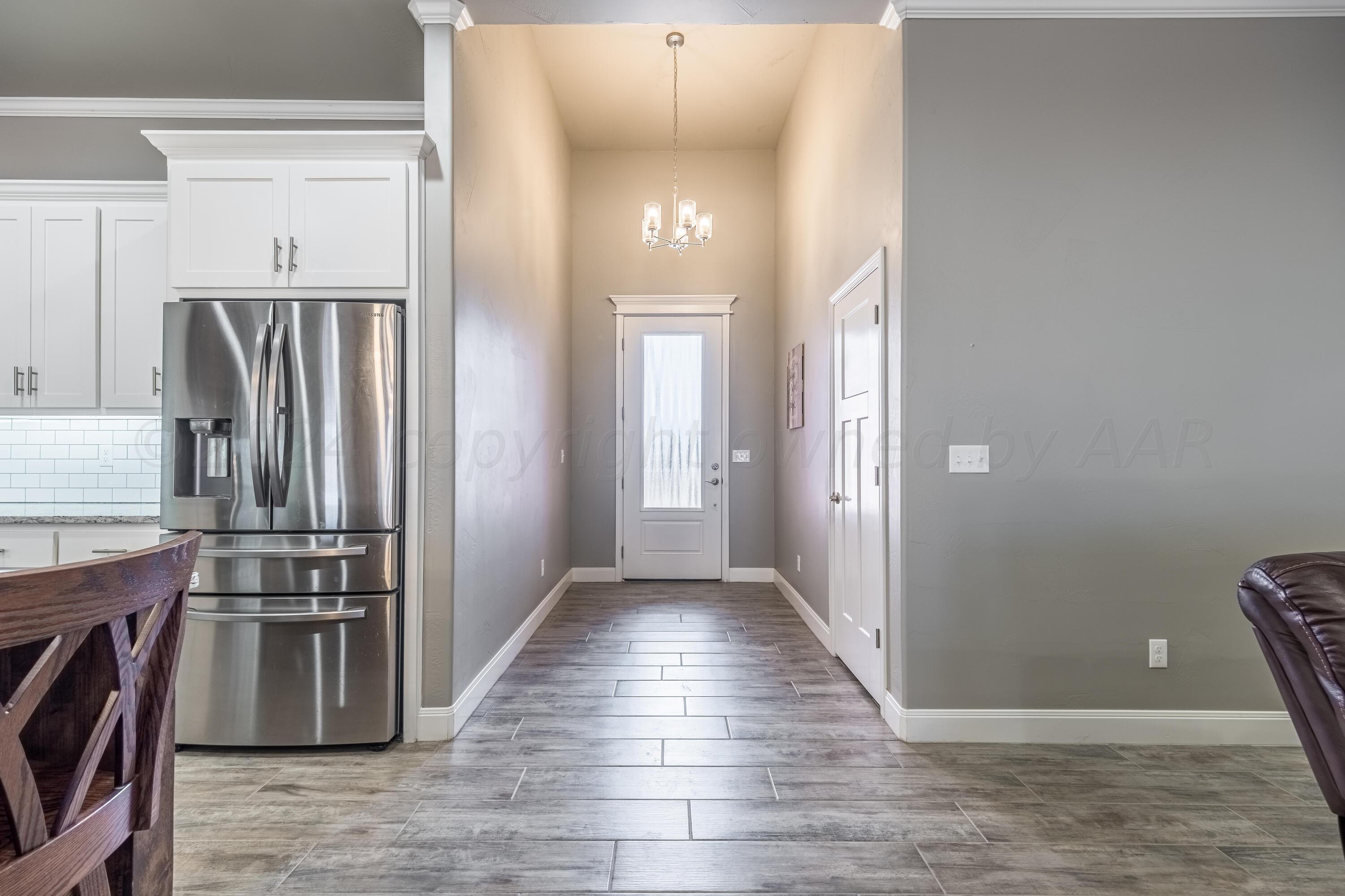 5 Gimball Drive Canyon, TX 79015 - Photo 5 of 36 a view of a kitchen with wooden floor and a refrigerator