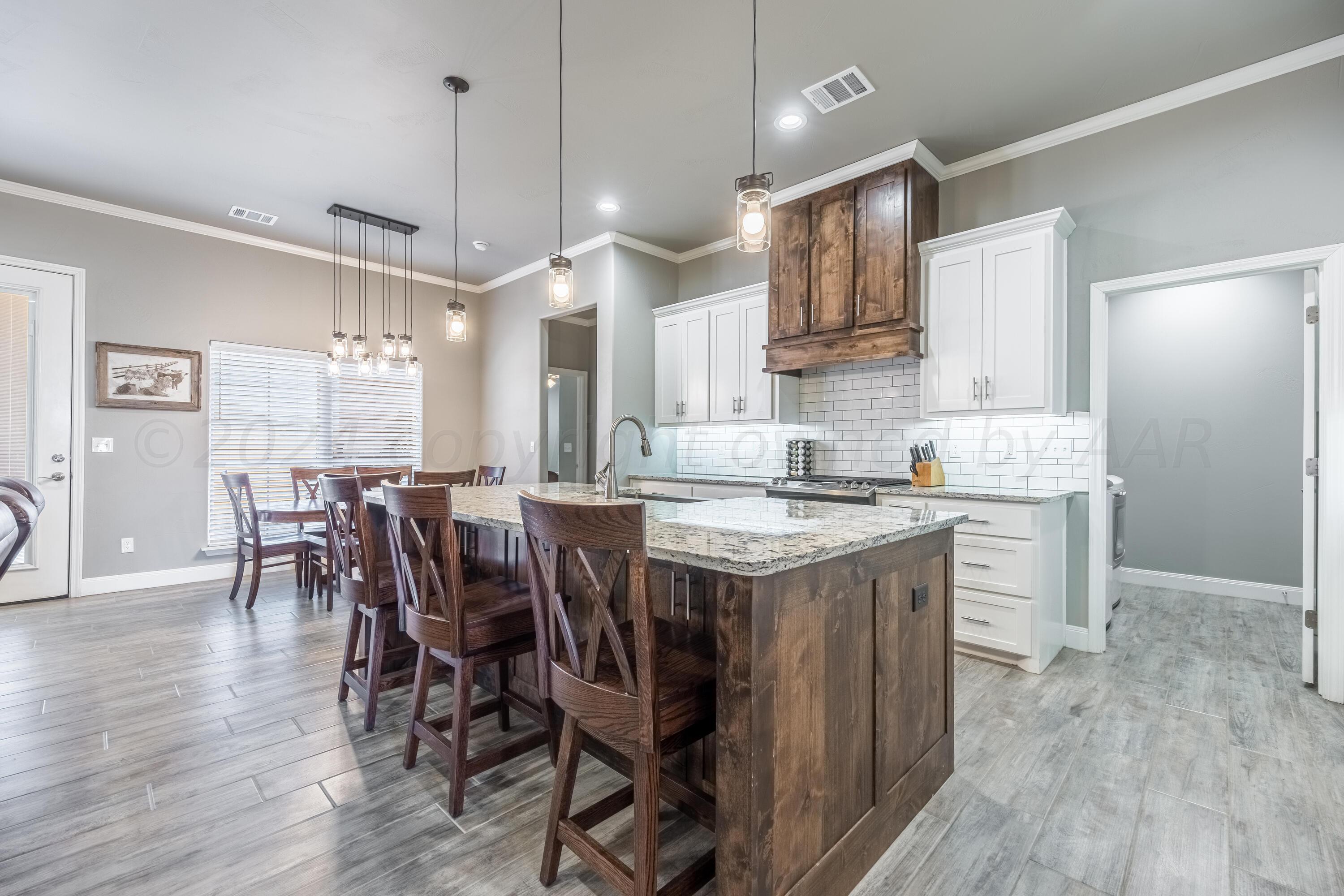 5 Gimball Drive Canyon, TX 79015 - Photo 6 of 36 a kitchen with a table chairs refrigerator and microwave