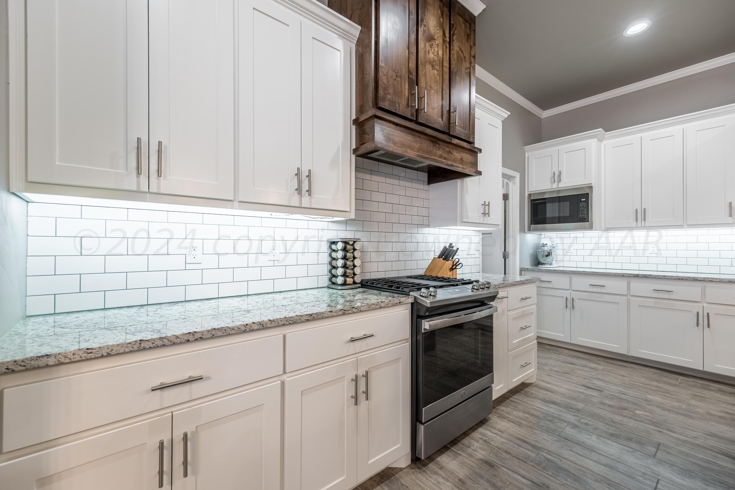 5 Gimball Drive Canyon, TX 79015 - Photo 7 of 36 a kitchen with granite countertop white cabinets and white appliances