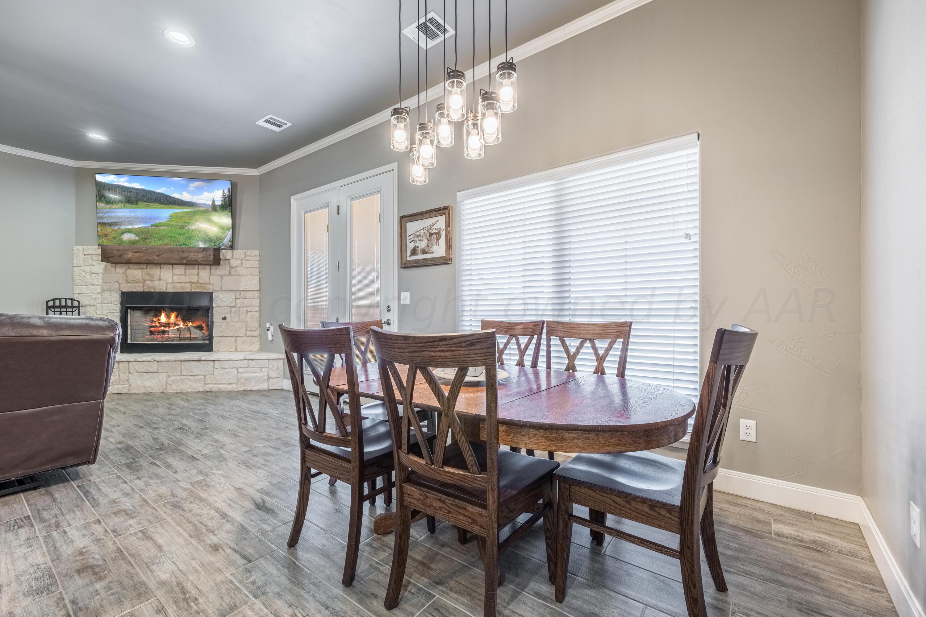 5 Gimball Drive Canyon, TX 79015 - Photo 10 of 36 a view of a dining room with furniture a chandelier and wooden floor