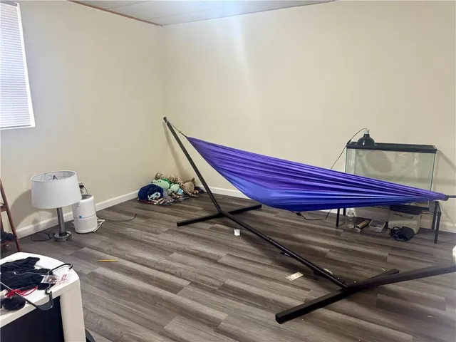 a view of a room with wooden floor and furniture