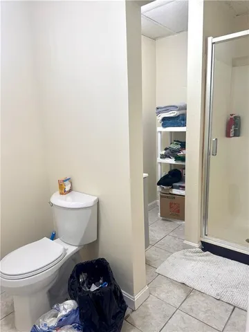 a bathroom with a toilet and a shower