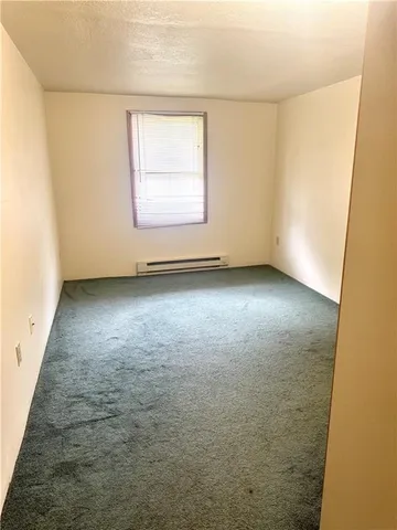 an empty room with a empty space and a window
