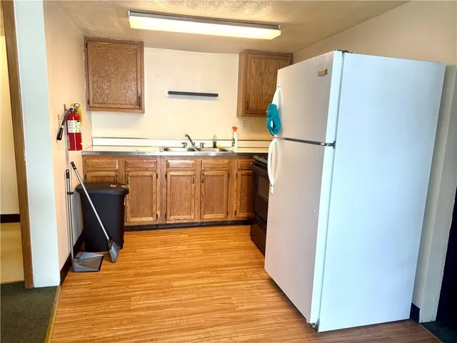 a kitchen with a refrigerator a stove top oven and a refrigerator