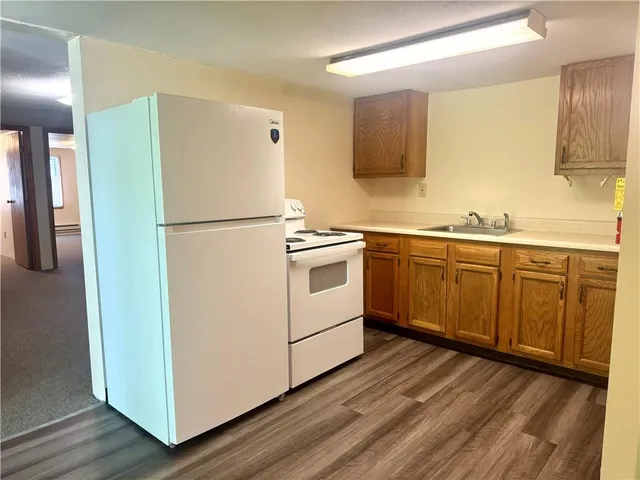 a view of a room with a kitchen