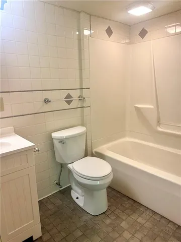 a utility room with lots of clutter and stainless steel appliances