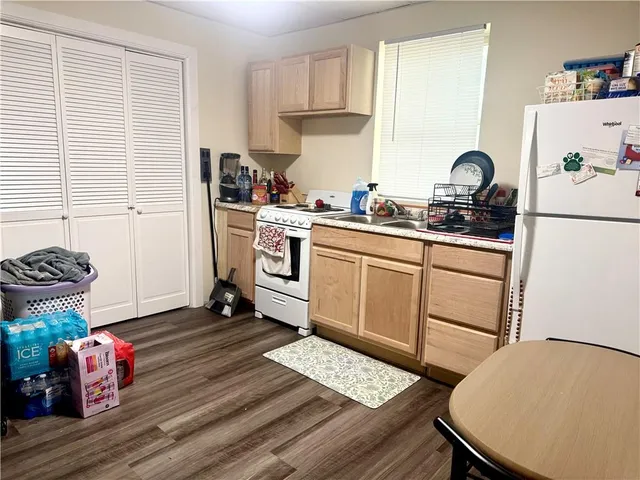 a kitchen with a sink appliances and cabinets