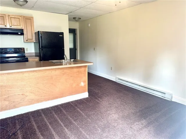 a kitchen with stainless steel appliances a refrigerator and a stove