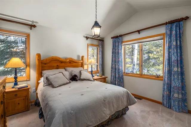 a front view of a house with yard and parking