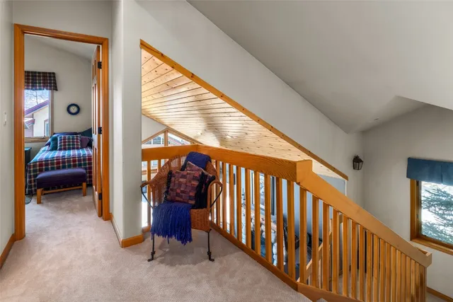 a bedroom with two beds lamp and a large window with rug