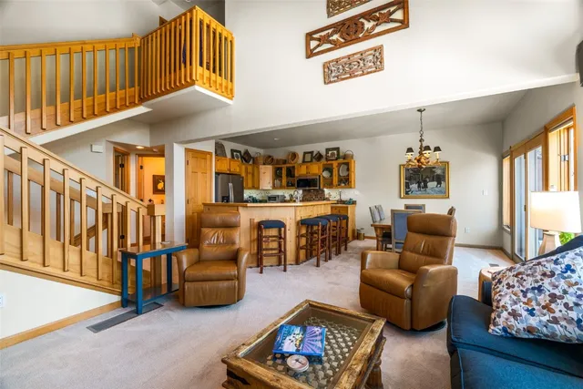 a living room with furniture a rug and a chandelier