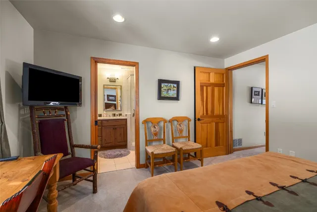 a bedroom with furniture and a flat screen tv