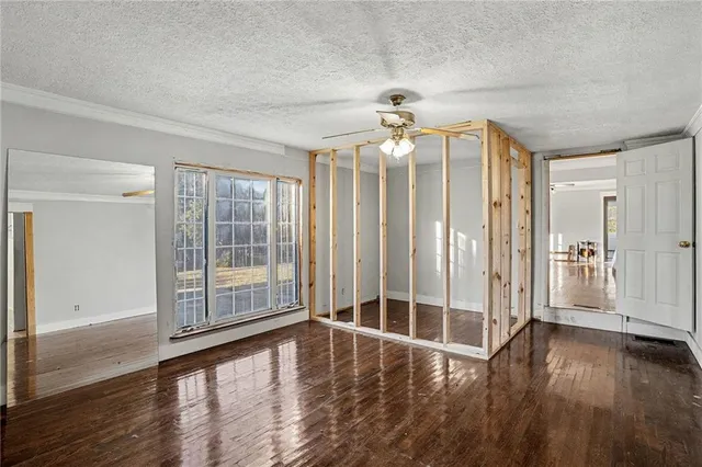 a view of wooden floor and chandelier fan in an empty room