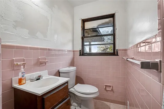 a bathroom with a sink toilet and window