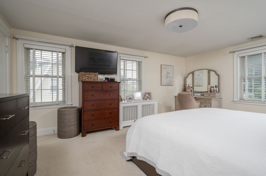 45 Rowe Street Milton, MA 02186 - Photo 17 of 34 a bedroom with a bed and a flat screen tv