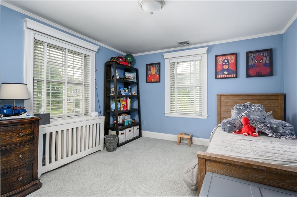 45 Rowe Street Milton, MA 02186 - Photo 19 of 34 a bedroom with furniture and a window