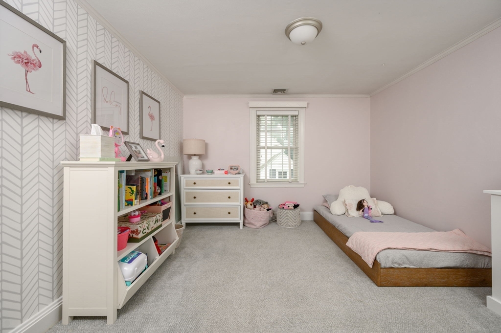 45 Rowe Street Milton, MA 02186 - Photo 20 of 34 a bedroom with a bed and a window