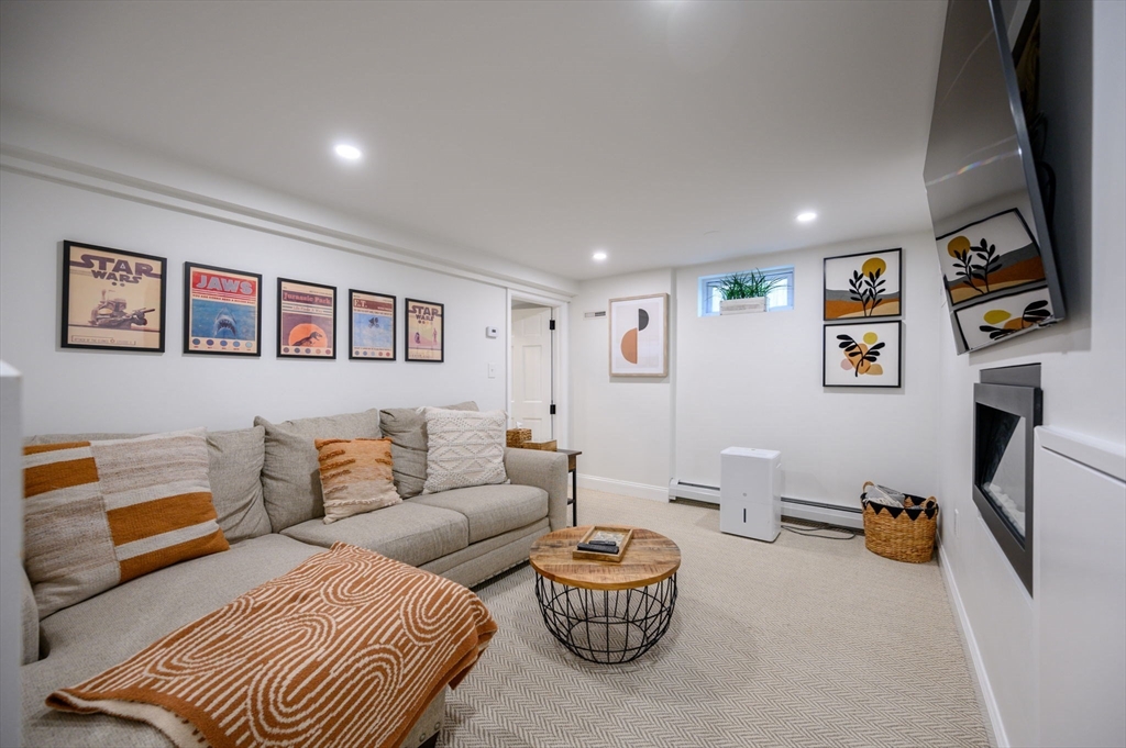 45 Rowe Street Milton, MA 02186 - Photo 21 of 34 a living room with furniture and a flat screen tv