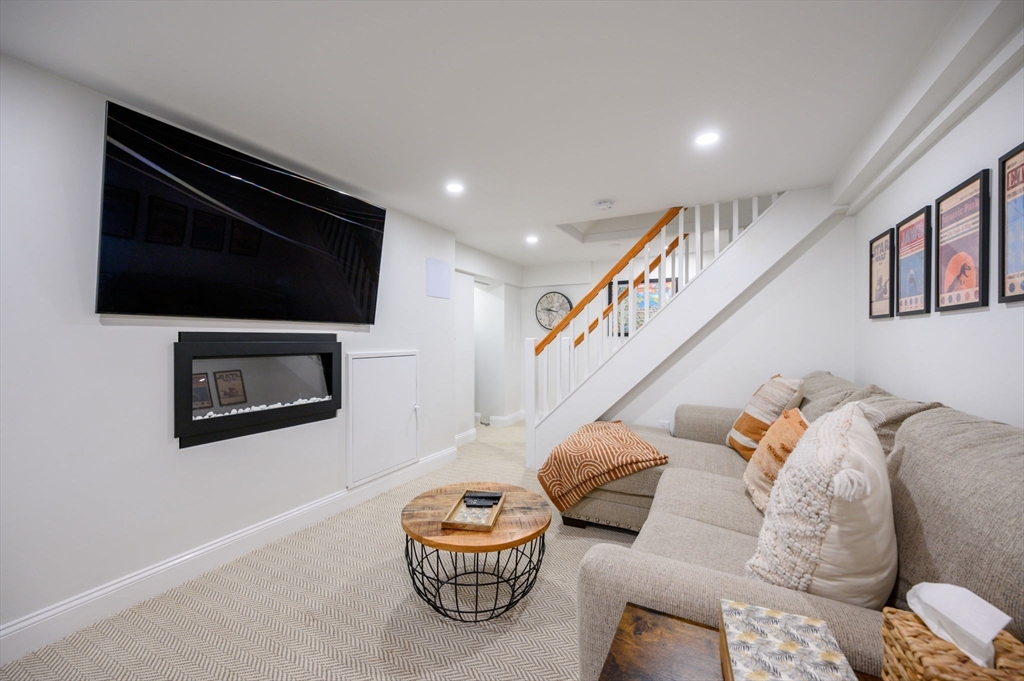 45 Rowe Street Milton, MA 02186 - Photo 22 of 34 a living room with furniture and a flat screen tv