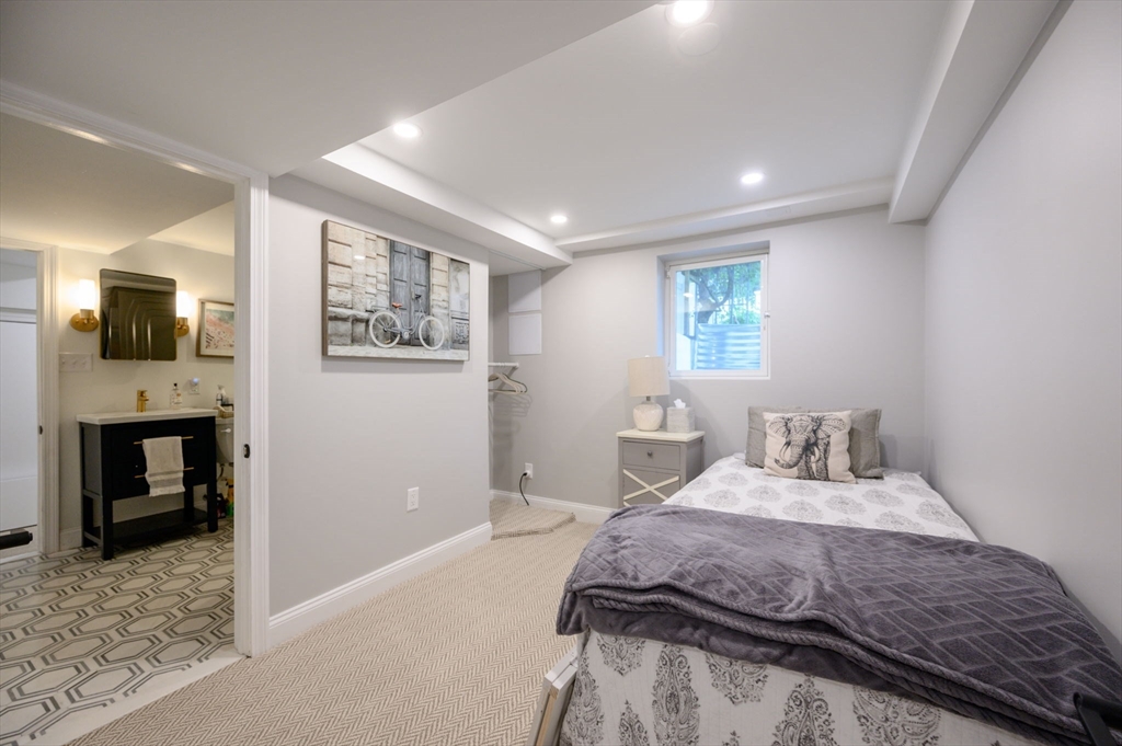 45 Rowe Street Milton, MA 02186 - Photo 23 of 34 a bedroom with a bed and a television