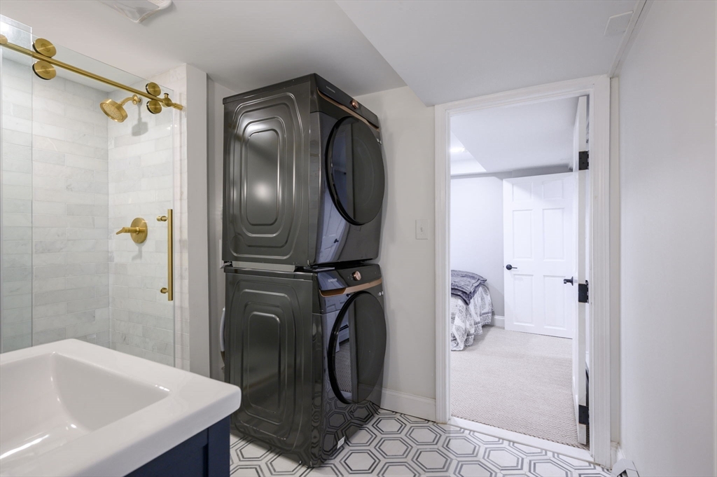 45 Rowe Street Milton, MA 02186 - Photo 25 of 34 a bathroom with a sink a toilet and shower