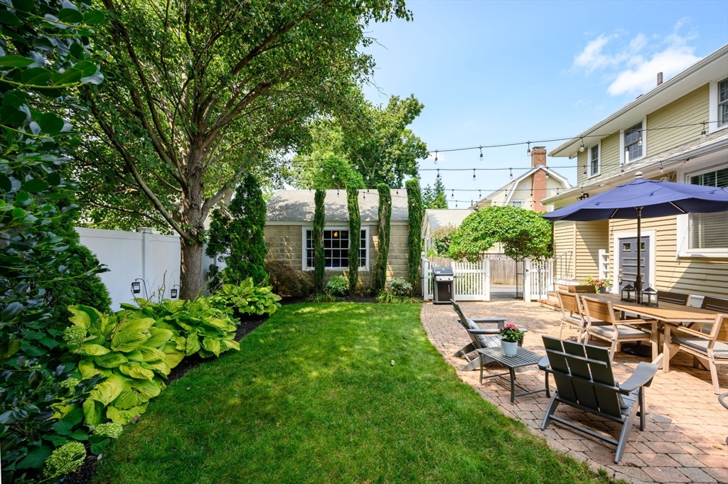 45 Rowe Street Milton, MA 02186 - Photo 30 of 34 a view of a patio with table and chairs potted plants and large tree