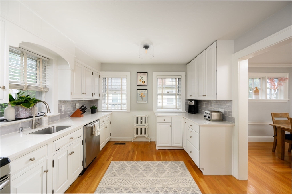 45 Rowe Street Milton, MA 02186 - Photo 3 of 34 a kitchen with a sink a window and cabinets